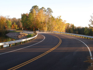 Curving asphalt road near sunset