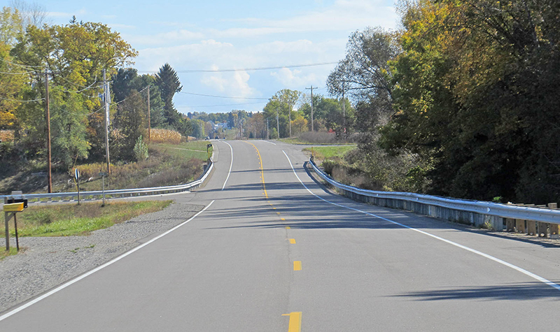 Looking down roadway with guardrails on either side