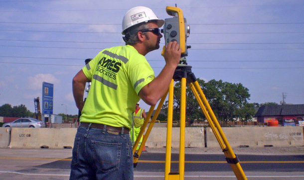 Ayres surveyor using tripod mounted equipment