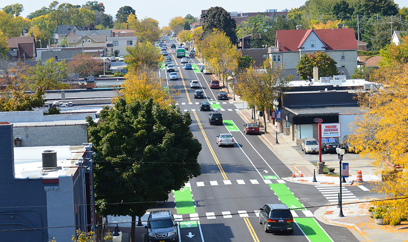 Aerial photo looking down a complete street with painted bike lanes.