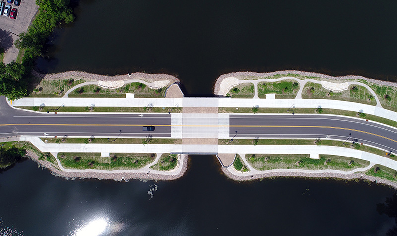 Aerial Shot of a bridge featuring a complete street with enhanced landscape aesthetics.