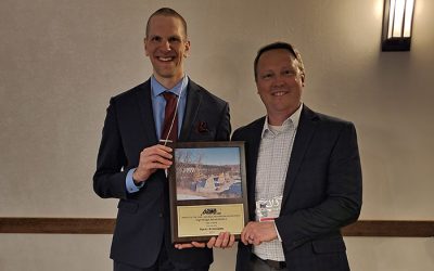 Ayres' Joseph Bluma and Dan Sydow standing with the award.